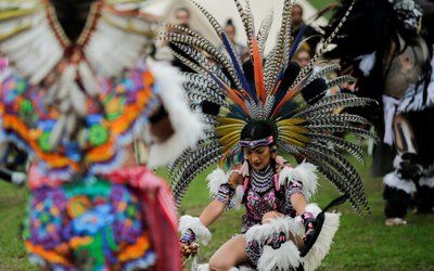A reveller perform a dance during a "pow-wow" celebrating the Indigenous Peoples' Day Festival in Randalls Island, in New York
