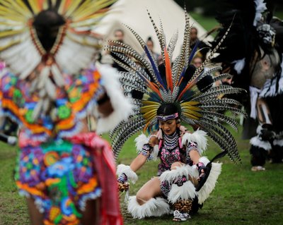 A reveller perform a dance during a "pow-wow" celebrating the Indigenous Peoples' Day Festival in Randalls Island, in New York
