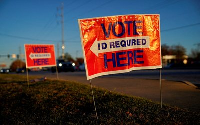 FILE PHOTO: Voters line up to cast their ballots for the U.S. Senate runoff election in Columbus