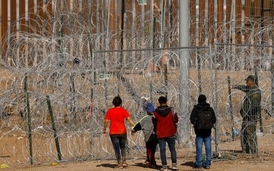 Migrants gather near razor wire on U.S.-Mexico border, as seen from Ciudad Juarez