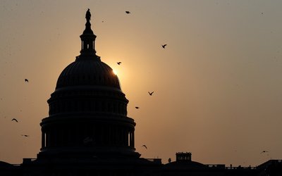FILE PHOTO: The sun rises behind the U.S. Capitol in Washington