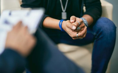 Close-up of black adolescent having a therapy session with psychologist.