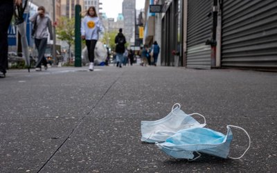 A pair of discarded face masks sit on the side walk in New York City