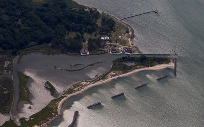 A partial seawall is seen near houses along the water's edge on Tangier Island