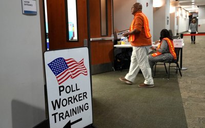 Election workers oversee early election voting at a polling station in Marietta