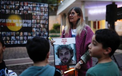 Family members of hostages gather to light candles to mark the first night of the Jewish holiday of Hanukkah, in Karmiel