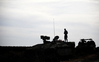 An Israeli soldier stands atop an APC vehicle near the ceasefire line between Syria and the Israeli-occupied Golan Heights