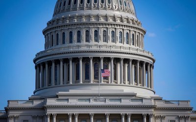 An American flag flies at the U.S. Capitol on day 30 of a partial government shutdown