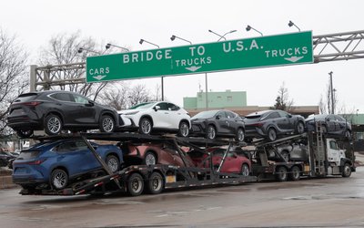 A car hauler drives towards the Ambassador Bridge to Detroit, Michigan from Windsor
