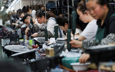 Employees of Gstar Electronic Appliance Co., Ltd work to assemble air fryers in the factory