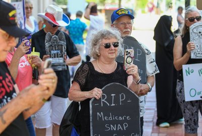 Davenporters Stage Mock Funeral Protest Against Medicaid Cuts at Senator Joni Ernst's Office
