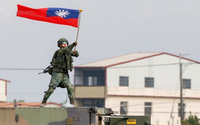 Taiwanese army soldier waves a flag during an annual military exercise ahead of Lunar New Year in Taichung