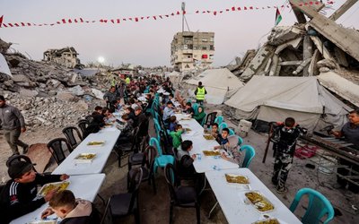Palestinians gather to break their fast by eating Iftar meals on the first day of the holy month of Ramadan, in Gaza City
