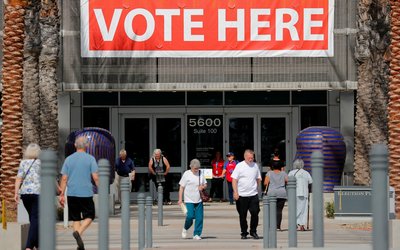 People come and go from the Registrar of Voters office on the final day of voter registration in the upcoming congressional elections in San Diego, California