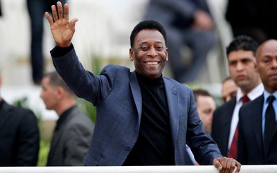 FILE PHOTO: Brazilian soccer legend Pele waves during the international friendly soccer match between Algeria and Slovenia in Algiers