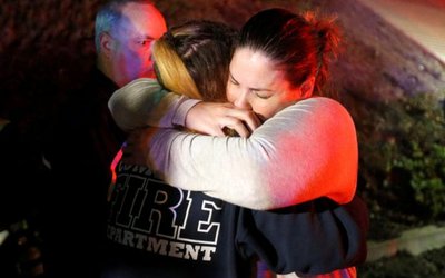 People comfort each other after a mass shooting at a bar in Thousand Oaks