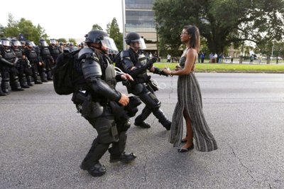 FILE PHOTO -- Lone activist Ieshia Evans stands her ground while offering her hands for arrest as she is charged by riot police during a protest against police brutality outside the Baton Rouge Police Department in Louisiana