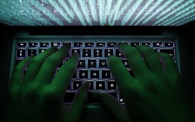 Illustration file picture shows a man typing on a computer keyboard in Warsaw