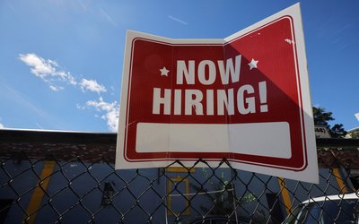 A "now hiring" sign is displayed in Somerville