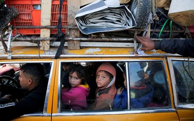 Displaced Palestinians make their way back to their homes in northern Gaza, amid a ceasefire between Israel and Hamas, in the central Gaza Strip