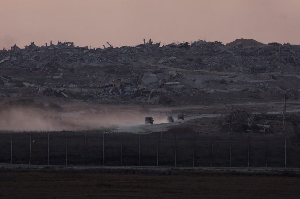 Israeli military vehicles manoeuvre inside Gaza, as seen from Israel