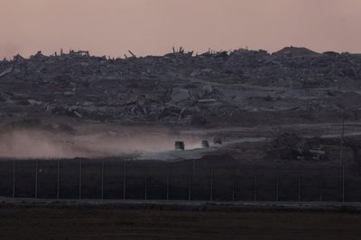 Israeli military vehicles manoeuvre inside Gaza, as seen from Israel