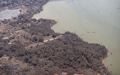 A general view from a New Zealand Defence Force P-3K2 Orion surveillance flight shows ash covered homes and vegetation over Nomuka in Tonga