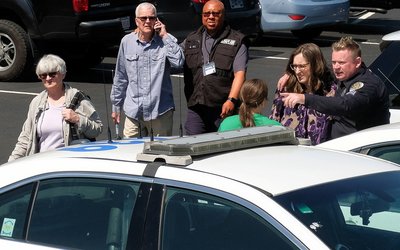 A police officer speaks with a woman at a family reunification center after a mass shooting in Nashville