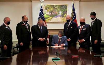 Handout photo of Georgia Governor Brian Kemp signing a restrictive voting bill